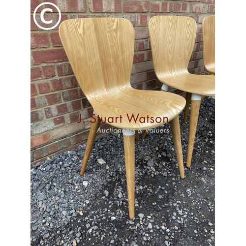 73 - A set of four designer bent ply chairs by Edelweiss