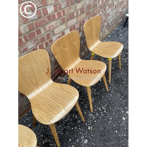 73 - A set of four designer bent ply chairs by Edelweiss