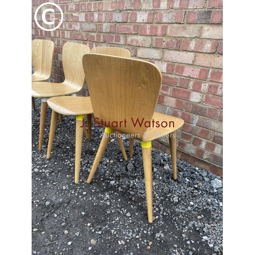 73 - A set of four designer bent ply chairs by Edelweiss