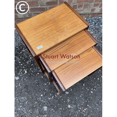 81 - A teak nest of three together with a retro tea trolley