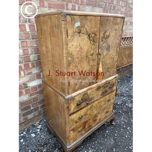 82 - A walnut gentleman's tallboy with linen cupboard over three drawers