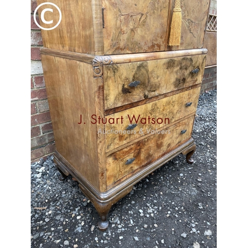 82 - A walnut gentleman's tallboy with linen cupboard over three drawers