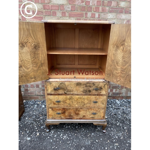 82 - A walnut gentleman's tallboy with linen cupboard over three drawers