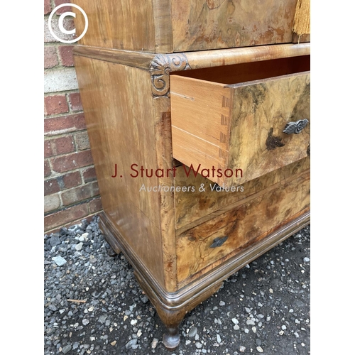 82 - A walnut gentleman's tallboy with linen cupboard over three drawers