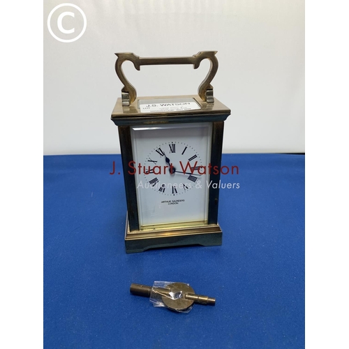 856 - Brass carriage clock and key in running order, no damage to glass