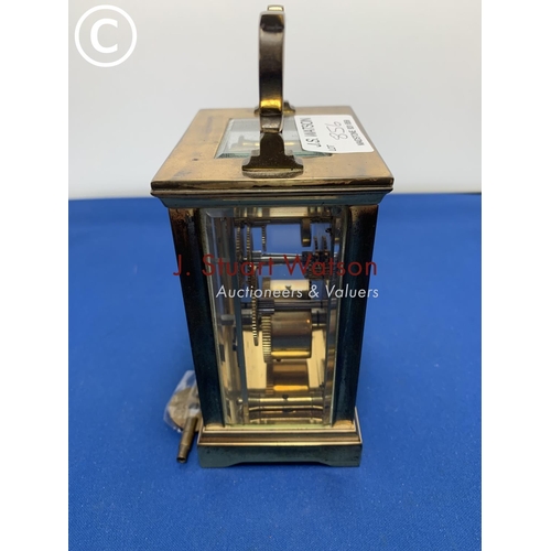 856 - Brass carriage clock and key in running order, no damage to glass