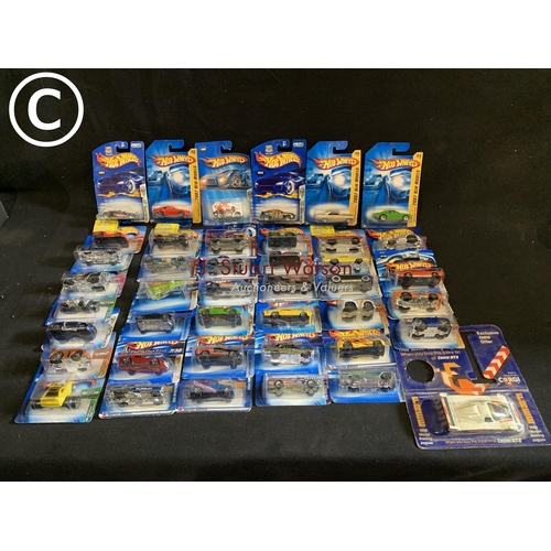 896 - Forty one Hot Wheels blister packs and model racing Jaguar