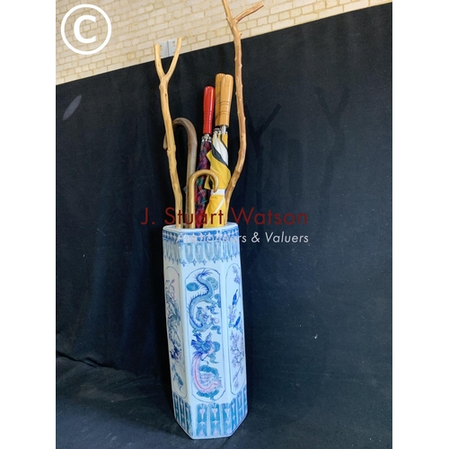 924 - Oriental blue and white umbrella stand height 60 cms, two thumb sticks, four umbrellas