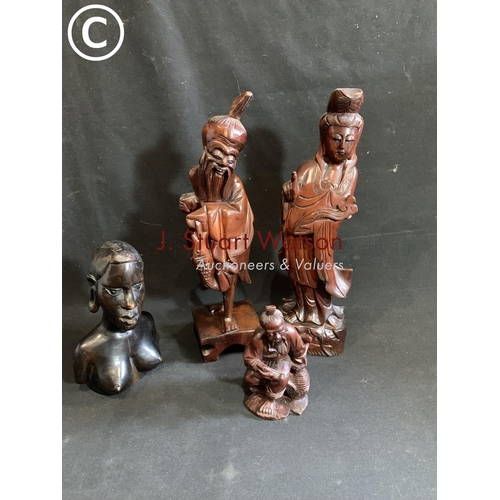 927 - Four carved wooden figures tallest 37 cms