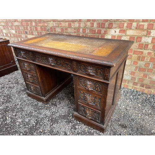 51 - A carved oak kneehole desk 122x70 x77