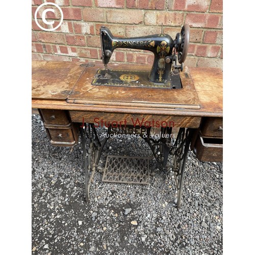 9 - A singer treddle sewing machine in cast iron base