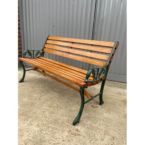 381 - A refurbished iron framed garden bench with varnished slatted seat