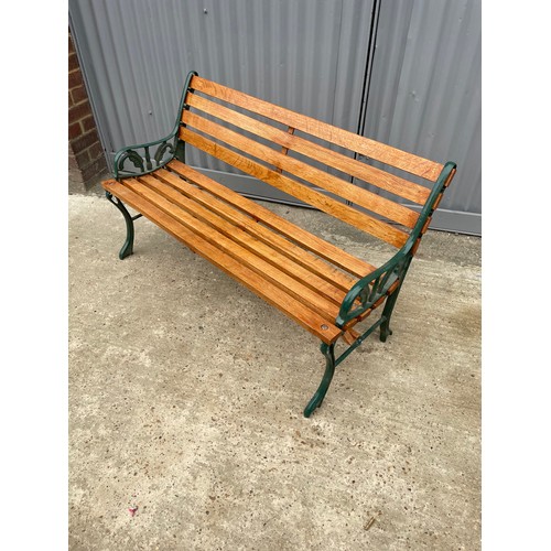 381 - A refurbished iron framed garden bench with varnished slatted seat