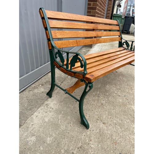 381 - A refurbished iron framed garden bench with varnished slatted seat