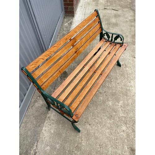 381 - A refurbished iron framed garden bench with varnished slatted seat