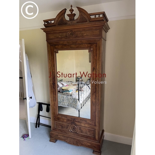 10 - A large french walnut and oak armoire wardrobe with mirror door over two drawers, fitted to the insi... 