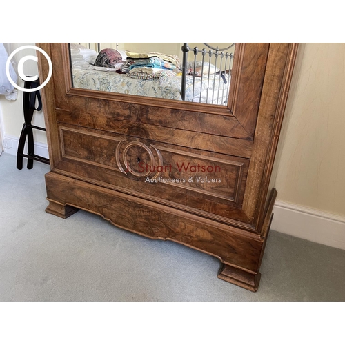 10 - A large french walnut and oak armoire wardrobe with mirror door over two drawers, fitted to the insi... 