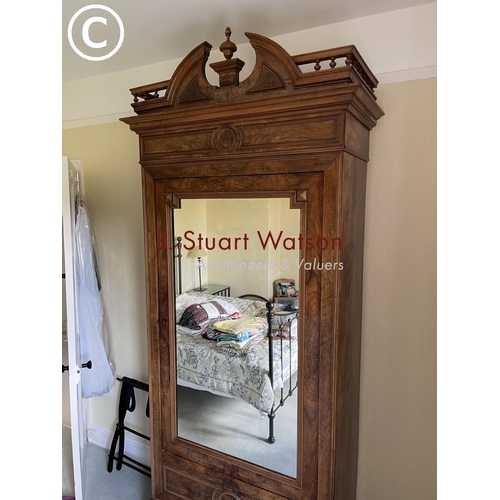 10 - A large french walnut and oak armoire wardrobe with mirror door over two drawers, fitted to the insi... 