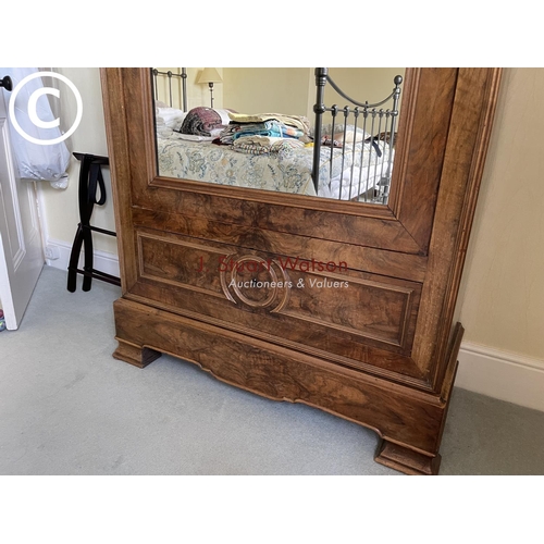 10 - A large french walnut and oak armoire wardrobe with mirror door over two drawers, fitted to the insi... 