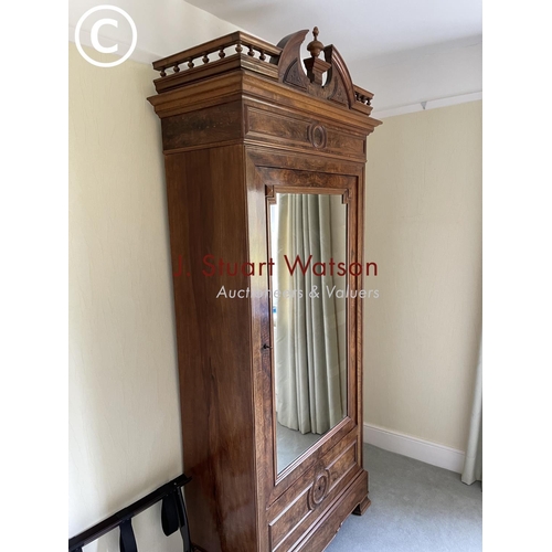 10 - A large french walnut and oak armoire wardrobe with mirror door over two drawers, fitted to the insi... 