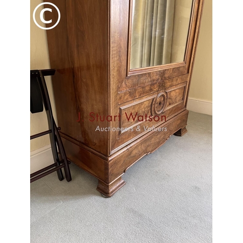 10 - A large french walnut and oak armoire wardrobe with mirror door over two drawers, fitted to the insi... 