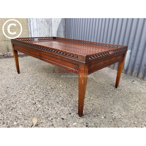 11 - A reproduction mahogany gallery top coffee table 120x70