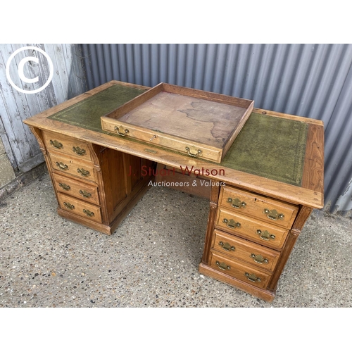 13 - An oak pedestal desk witrh a green leather top