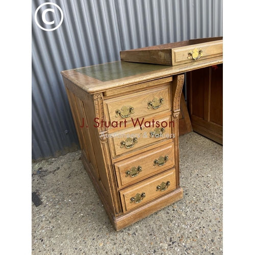 13 - An oak pedestal desk witrh a green leather top