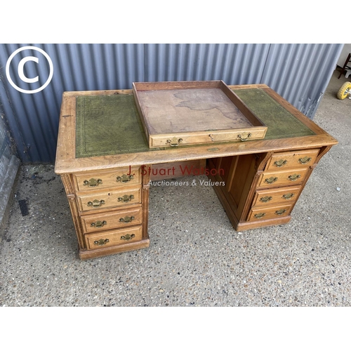 13 - An oak pedestal desk witrh a green leather top