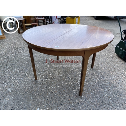 15 - A circular teak extending dining table