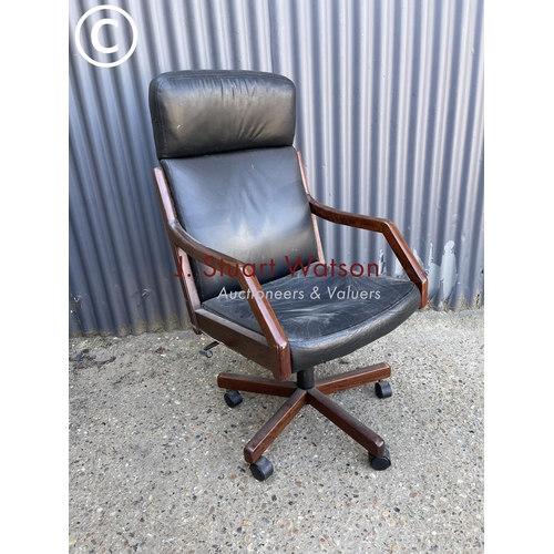 16 - A danish rosewood framed swivel office chair labelled to the underside