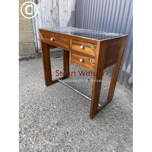 18 - A small Indonesian style three drawer desk