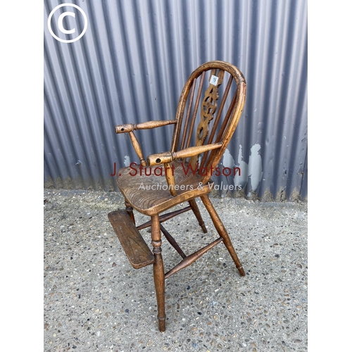 19 - An antique childs wheelback high chair