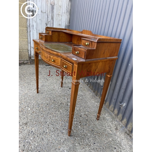 24 - A reproduction yew wood ladies writing desk