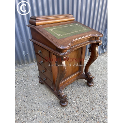 26 - A reproduction mahogany davenport with green leather top and fitted interior, four drawers to each s... 