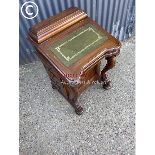 26 - A reproduction mahogany davenport with green leather top and fitted interior, four drawers to each s... 