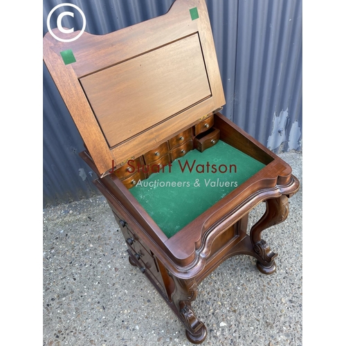 26 - A reproduction mahogany davenport with green leather top and fitted interior, four drawers to each s... 