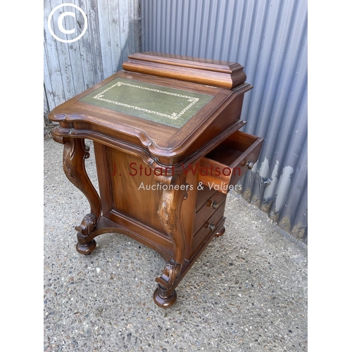 26 - A reproduction mahogany davenport with green leather top and fitted interior, four drawers to each s... 