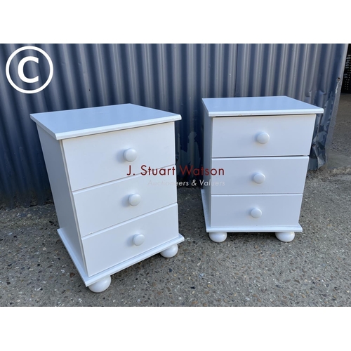 33 - A pair of modern white bedside chests of three drawers