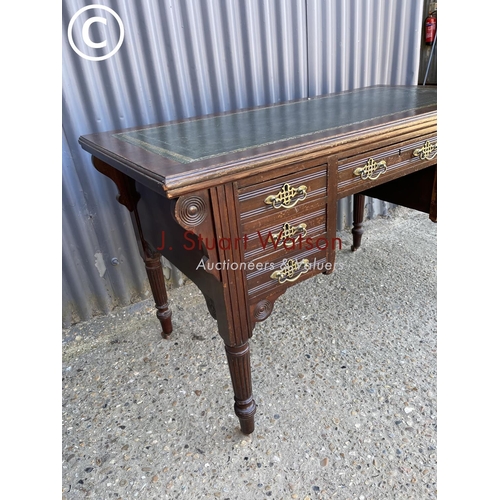 52 - An Edwardian kneehole writing desk with green leather top