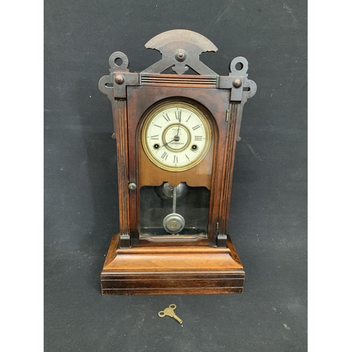 562 - Wooden wall clock with key and pendulum by Talbot of Canterbury