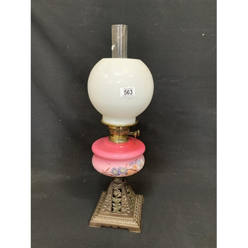 563 - Victorian oil lamp on cast iron base, total height 59cms, chimney cracked