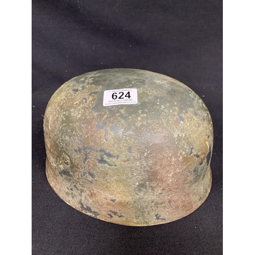 624 - German helmet, Camouflage showing through