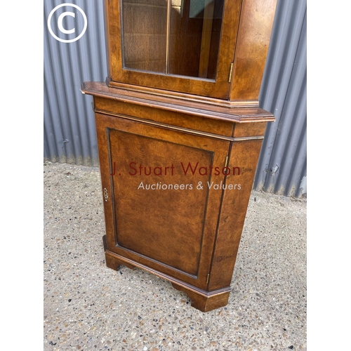 213 - A walnut reproduction corner cabinet