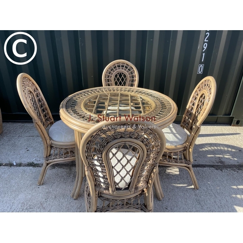 357 - Circular bamboo effect circular dining table with drop in glass top together with four matching chai... 