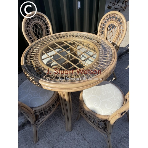 357 - Circular bamboo effect circular dining table with drop in glass top together with four matching chai... 