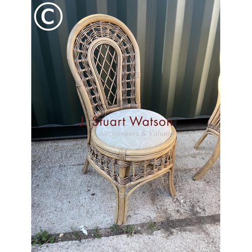 357 - Circular bamboo effect circular dining table with drop in glass top together with four matching chai... 