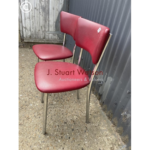 100 - A pair of red vinyl kitchen chairs