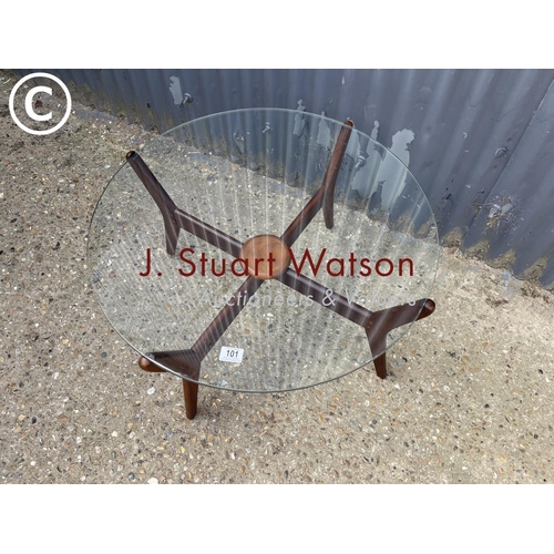 101 - A circular teak framed spider coffee table with glass top