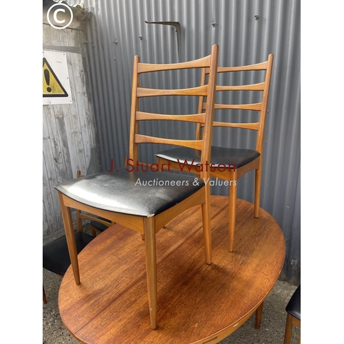 102 - A mid century teak table and six chairs by greaves and Thomas